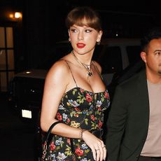 Taylor Swift wearing a black floral-print DOEN dress to Via Carota in NYC