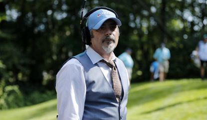 David Feherty looks on whilst someone plays their shot