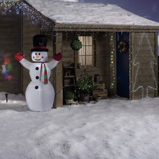 snow man with wooden house