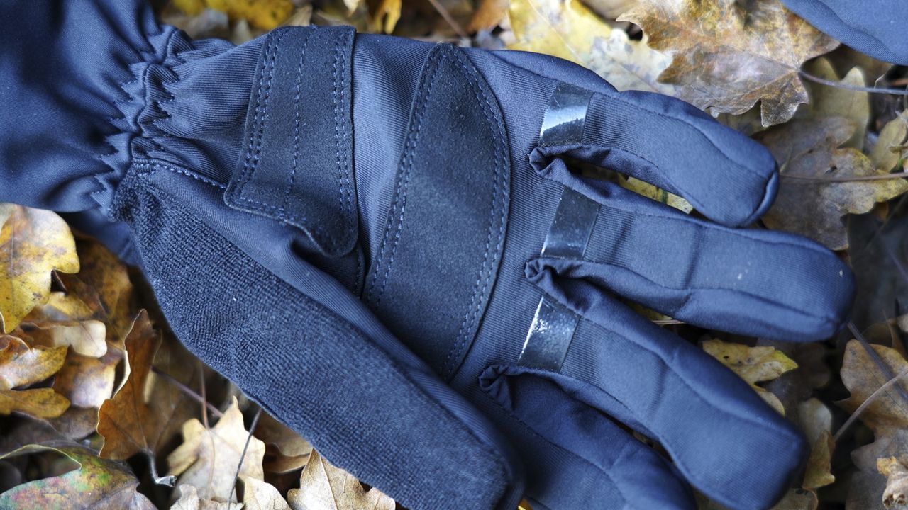 A close up of a Gore Windstopper Thermo glove on leafy ground