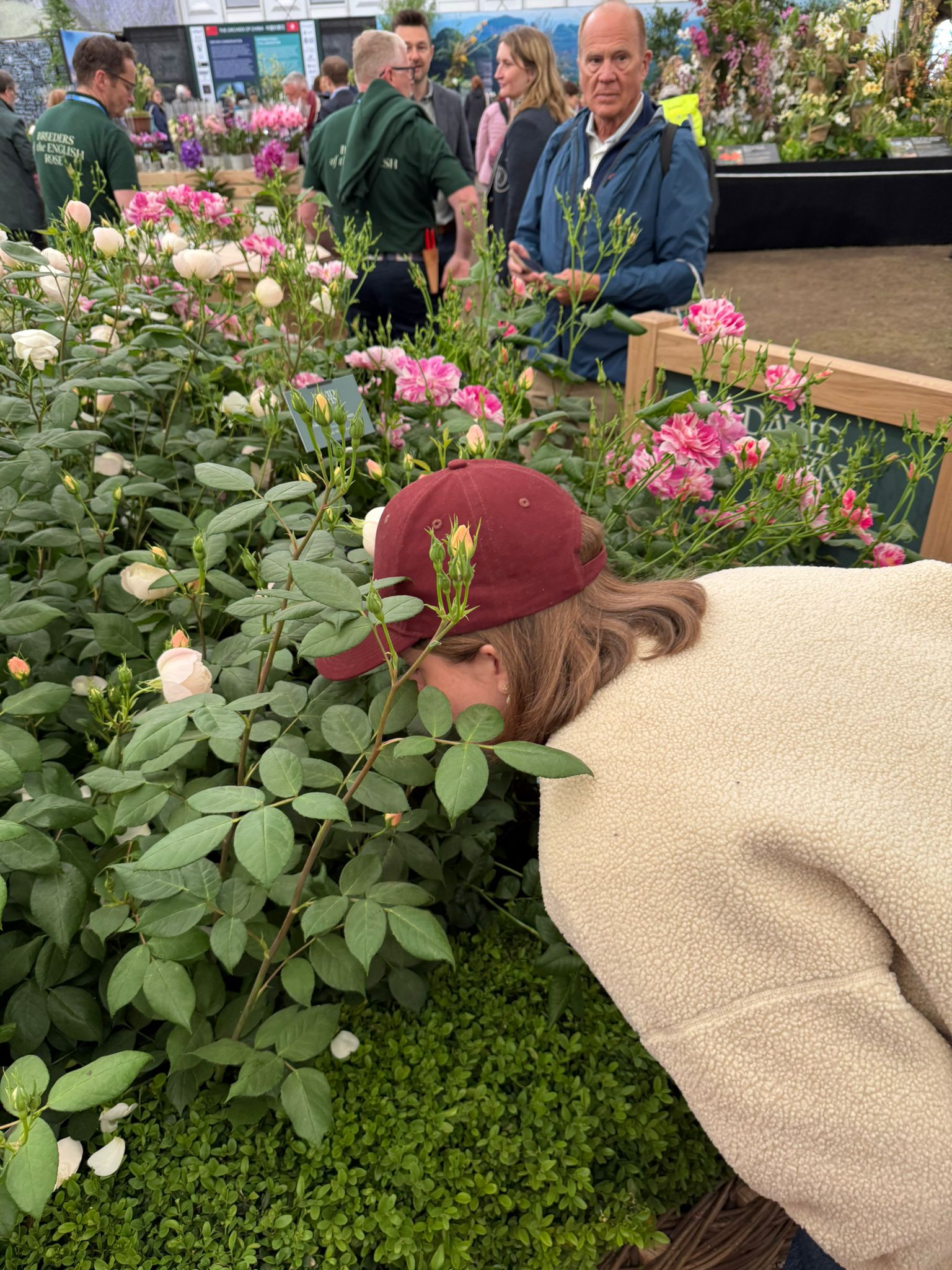 Rosie Paterson with her head in a bed of roses