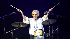 Mary Berry on stage with drums.