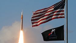 a rocket launches into a blue sky