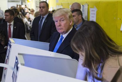 Donald Trump could not resist peeking over at his wife's ballot. 