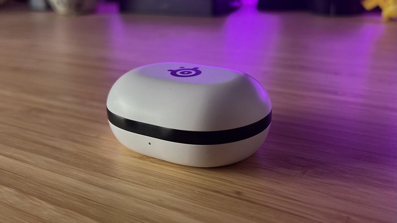 SteelSeries Arctis Game Buds case closed on a wooden desk