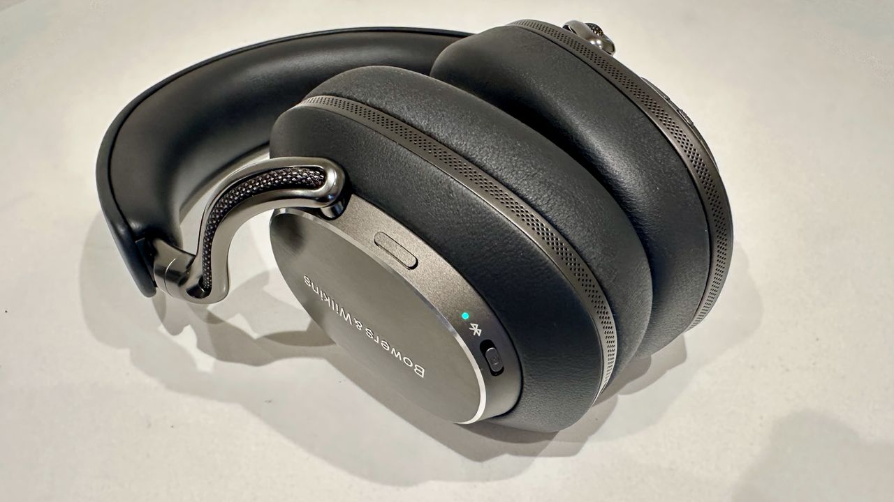 Bowers &amp; Wilkins Px8 S2 over-ear headphones, with Bluetooth light on, on a white surface