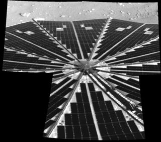 One of Phoenix Mars Lander's two octagonal solar panels, which open like two handheld, collapsible fans on either side of the spacecraft, has deployed successfully here. Beyond this view, the image shows a small sliver of the north polar terrain of Mars.