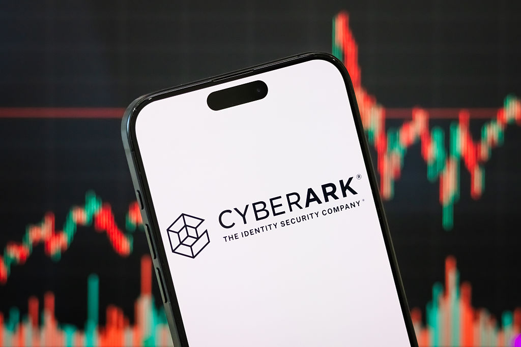 CyberArk Software logo on a smartphone with a stock chart in the background