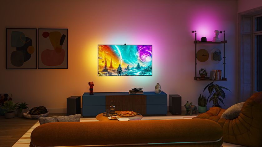 The Philips Smart Lighting  Screen Sync with Strip Light system lighting up the walls behind and beside a TV in a darkened room