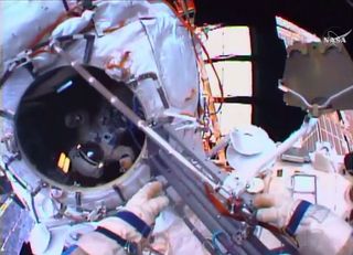 On Aug. 10, 2015, 2 cosmonauts completed Russian EVA 41 outside the International Space Station. Cosmonaut Mikhail Kornienko is seen inside the hatch (at left), while the hands of cosmonaut Gennady Padalka have just jettisoned an old cable.