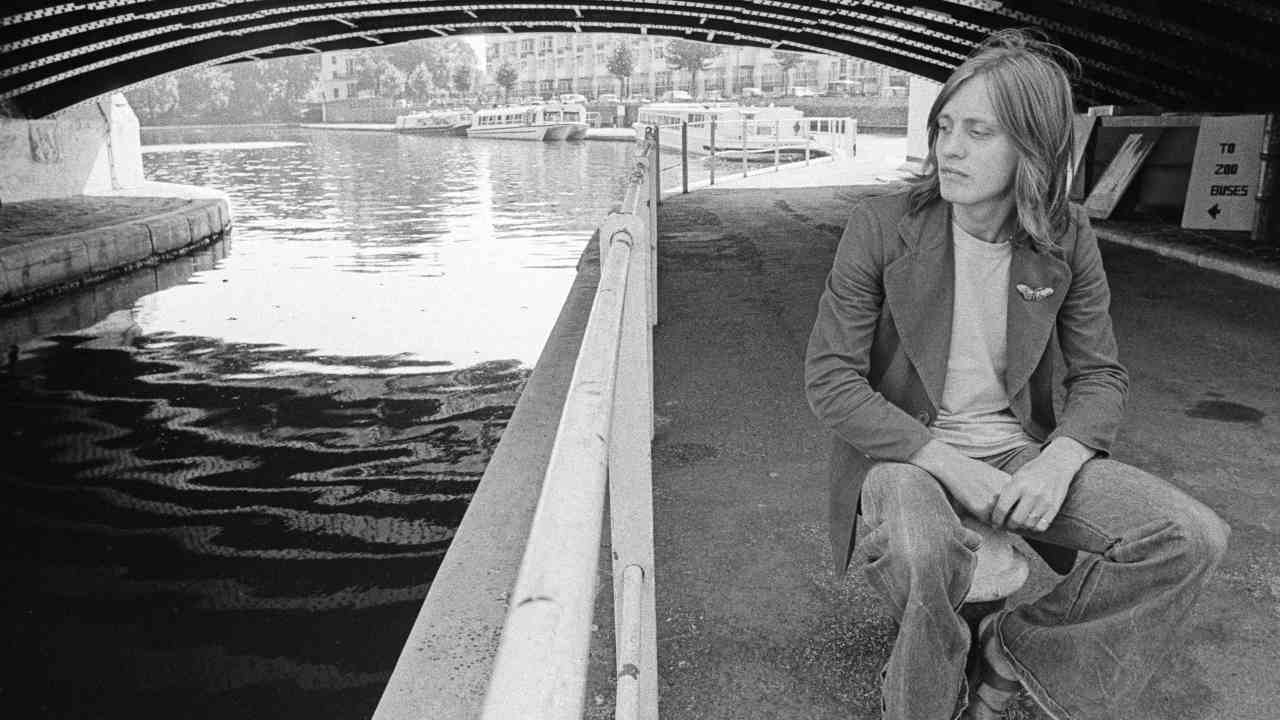 Jess Roden posing for a photograph under a canal bridge in the 1970s