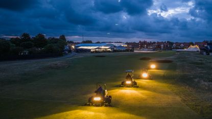 Greenkeepers mowing in the dark with their headlights on