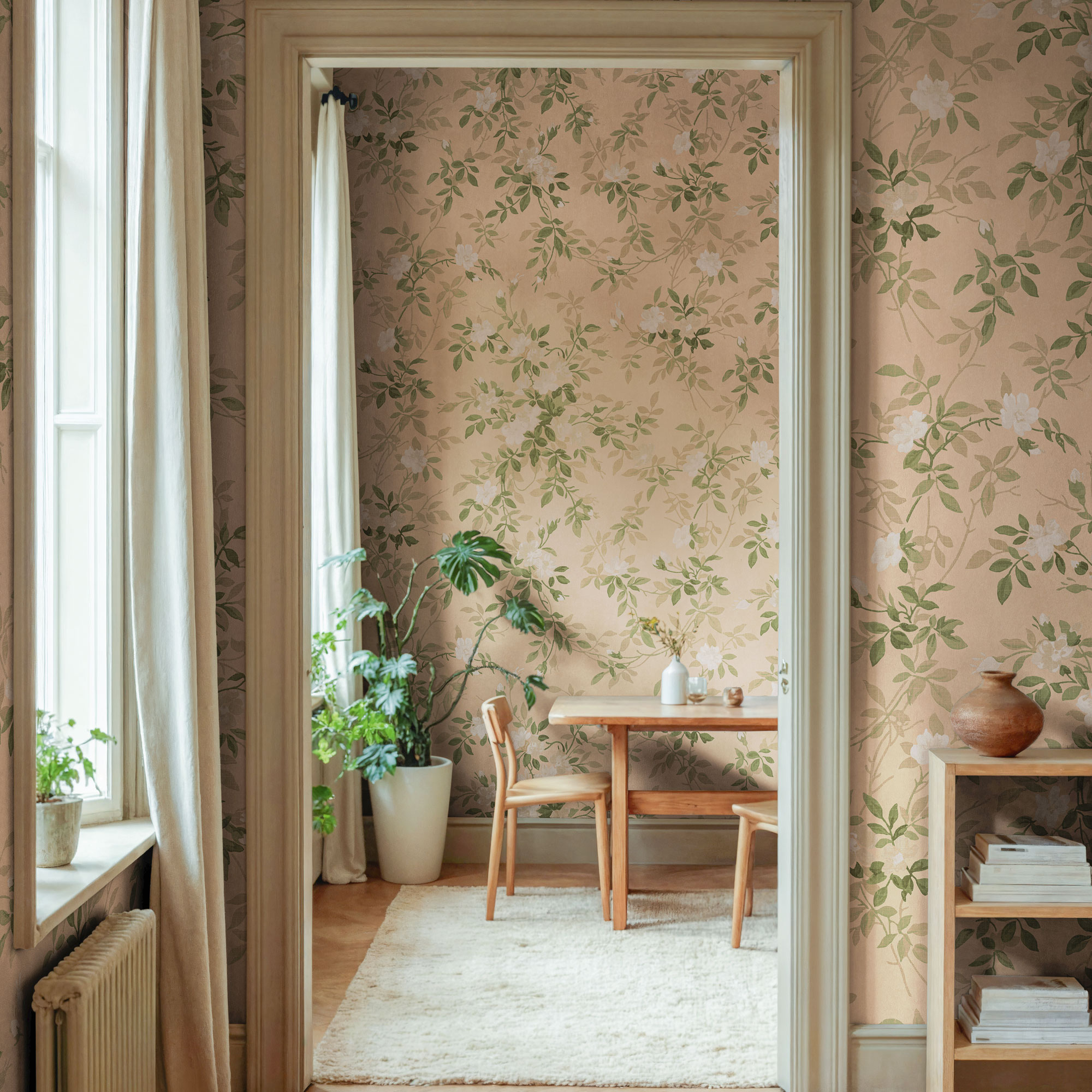 Faded pink wallpaper with sage green door frame