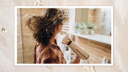 Image of woman blow drying grey hair, wearing a tartan shirt, on a pearlescent background 