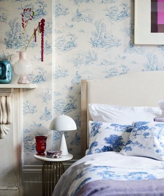 blue and white toile de jouy wallpaper on bedroom wall