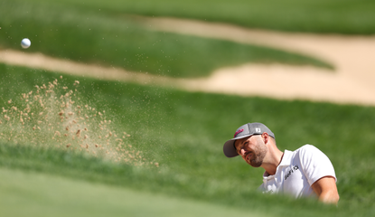 Wyndham Clark hits a bunker shot 