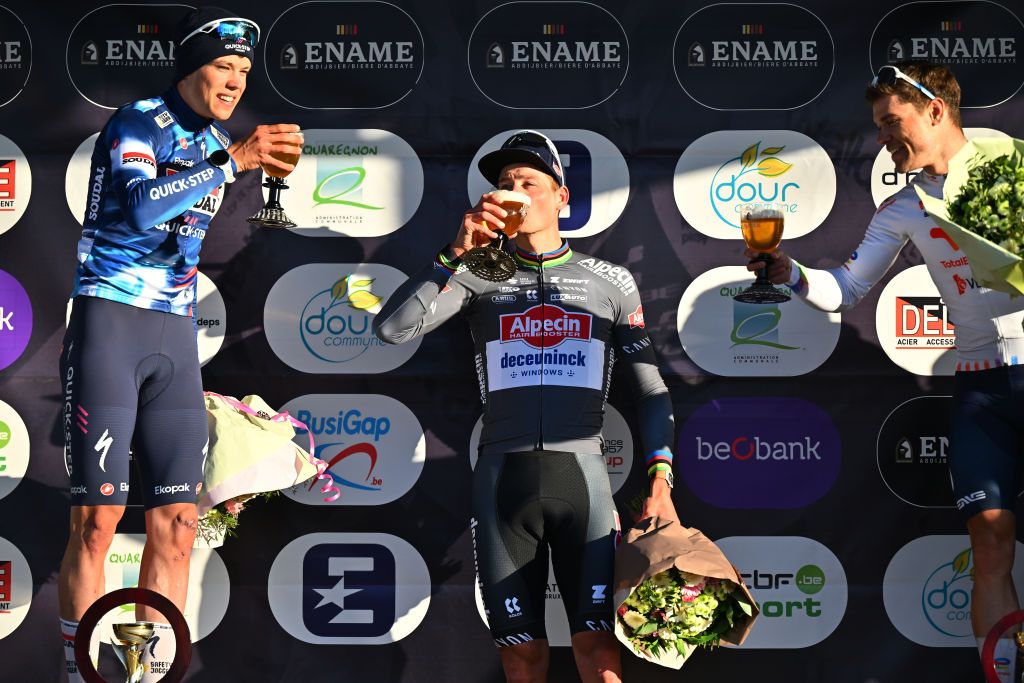 DOUR BELGIUM MARCH 04 LR Paul Magnier of France and Team Soudal QuickStep on second place race winner Mathieu van der Poel of Netherlands and Team Alpecin Deceuninck and Emilien Jeanniere of France and Team TotalEnergies on third place pose and celebrate with a beer on the podium ceremony after the 57th Ename Samyn Classic 2025 a 1991km one day race from Quaregnon to Dour on March 04 2025 in Dour Belgium Photo by Luc ClaessenGetty Images