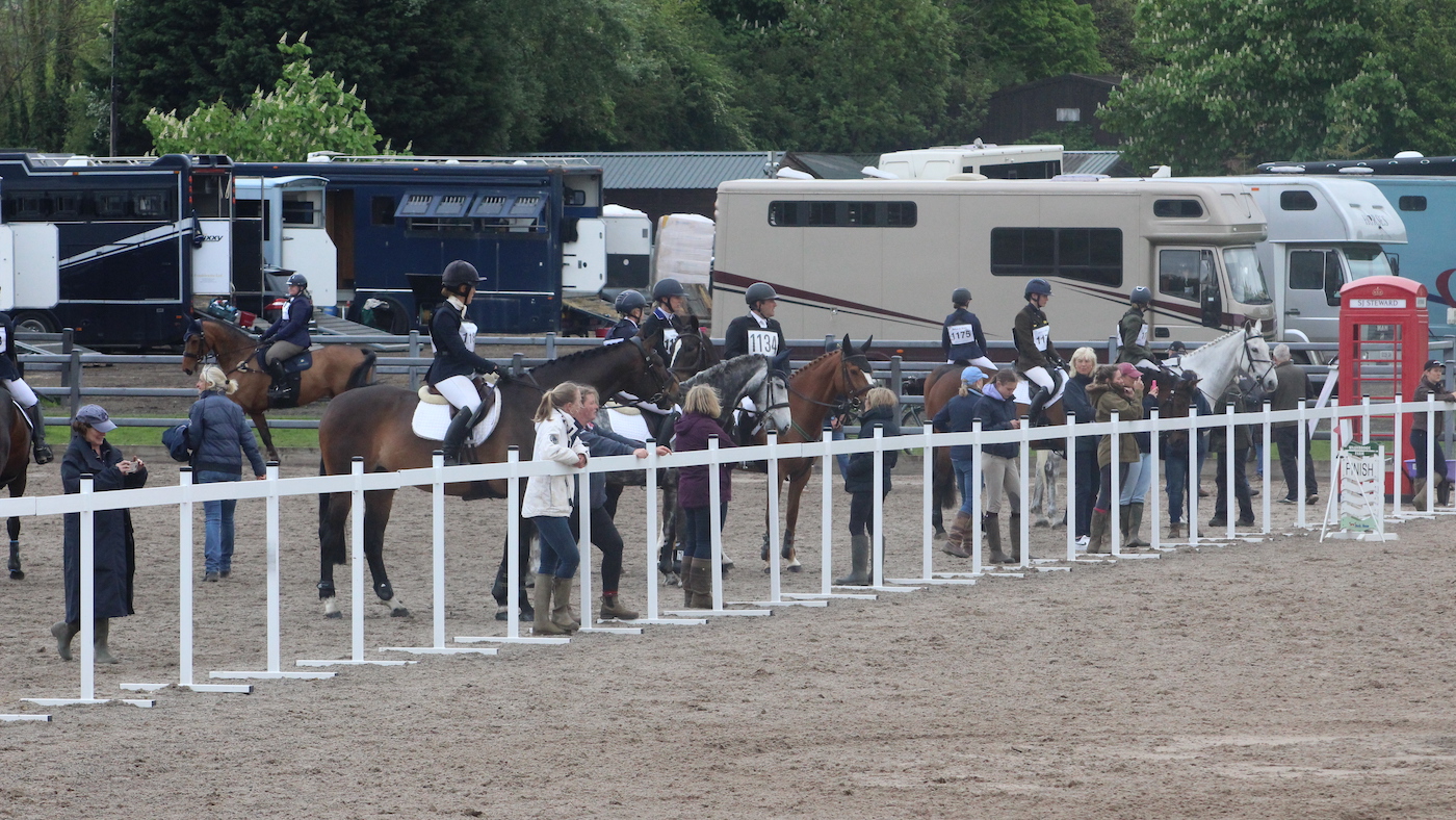Riders in warm-up at horse trials