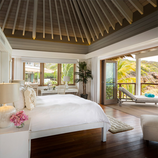bedroom with wooden flooring and bed with pillows