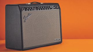 Fender Tone Master Deluxe guitar combo amp on an orange background