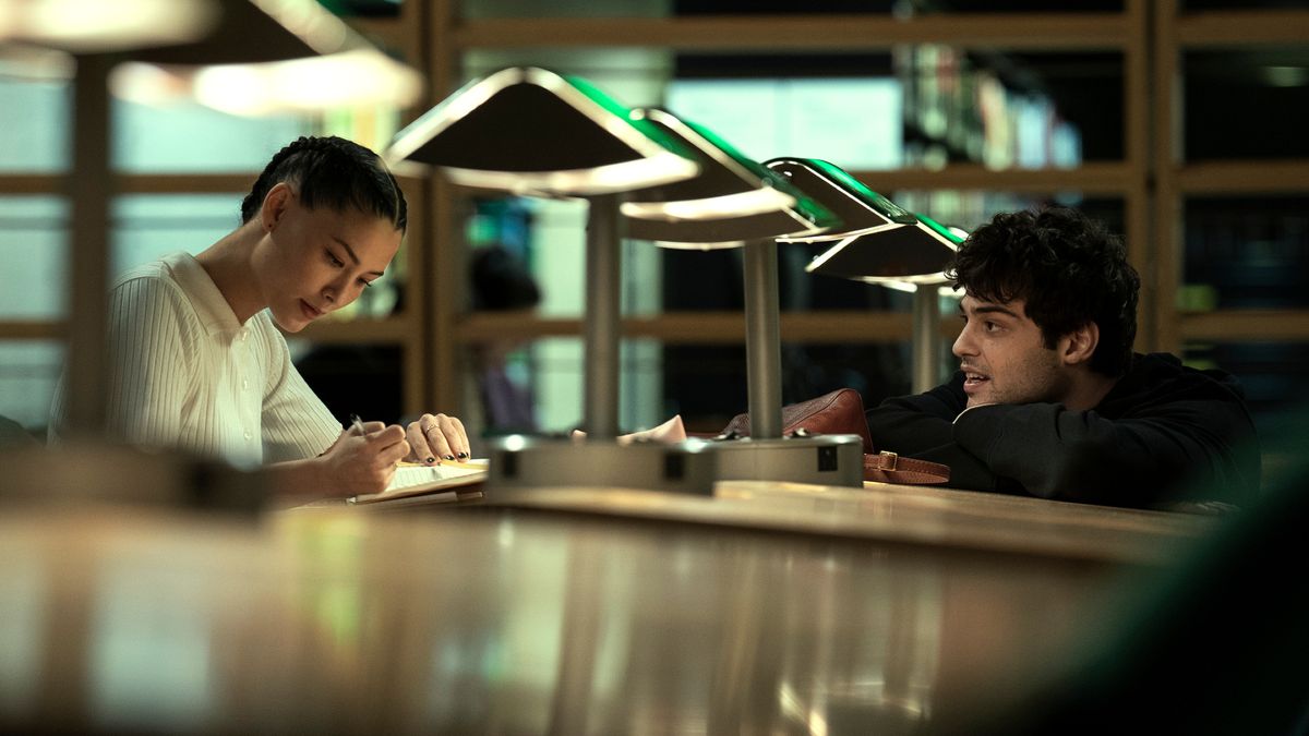 Hannah Copeland (Fivel Stewart) and Owen Hendricks (Noah Centineo) sit across from one another in an office in The Recruit