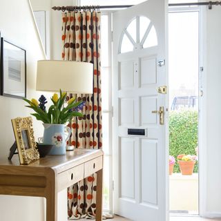 Open front door with curtain to pull across