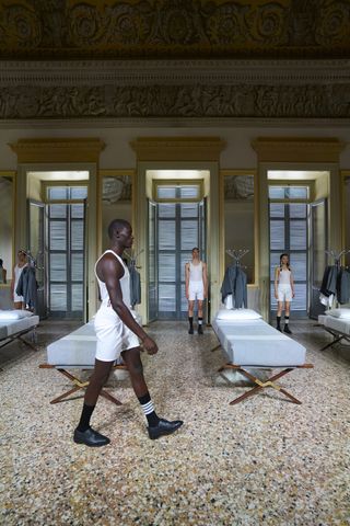 Thom Browne Frette Homeware Line at Milan Design Week: models in underwear stand by military-style beds for inspection