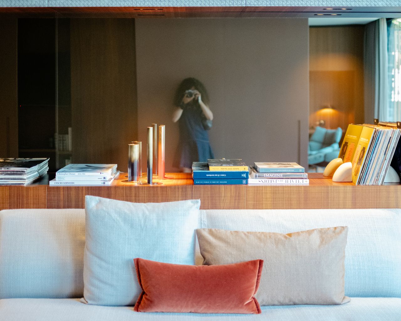 A mid-century modern-inspired hotel suite features earthy-tinted interiors, colorful design collectibles, and plenty of music equipment.