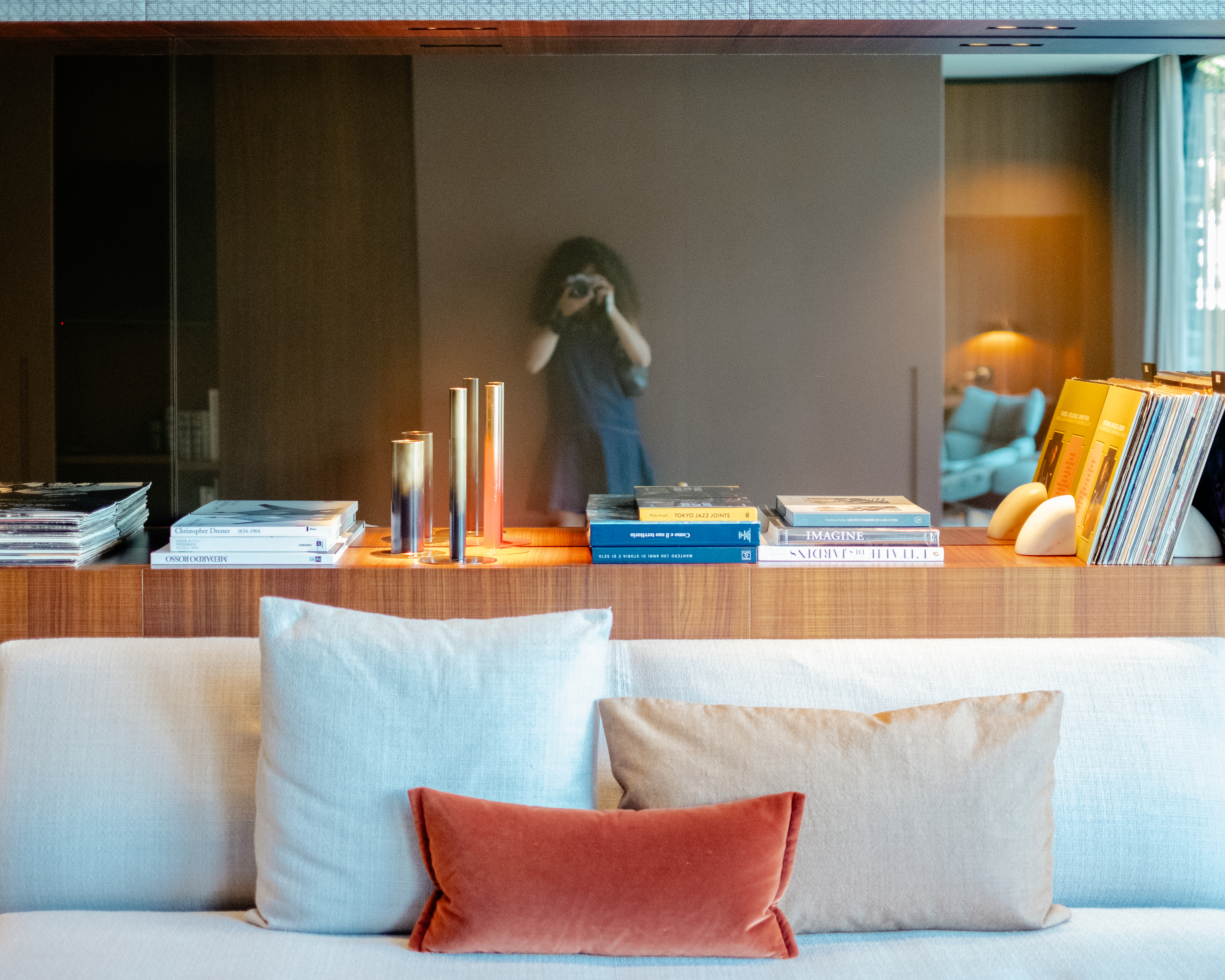 A mid-century modern-inspired hotel suite features earthy-tinted interiors, colorful design collectibles, and plenty of music equipment.