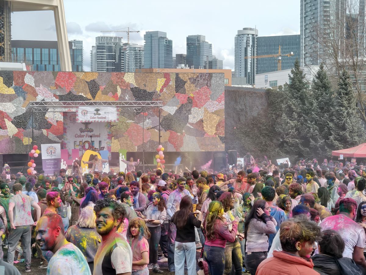 A group of people with colored powder everywhere