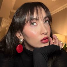 An image ofBest Knockoff Luxury Clothing
 associate beauty editor Alyssa Brascia wearing the It Cosmetics Do It All Sheer Tint Face Balm.