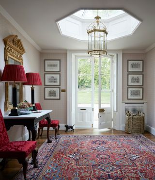Hallway decorated with antiques and rug