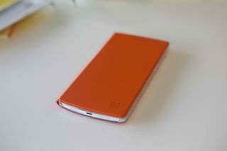 OnePlus One flip cover shown in a bright orange shade.