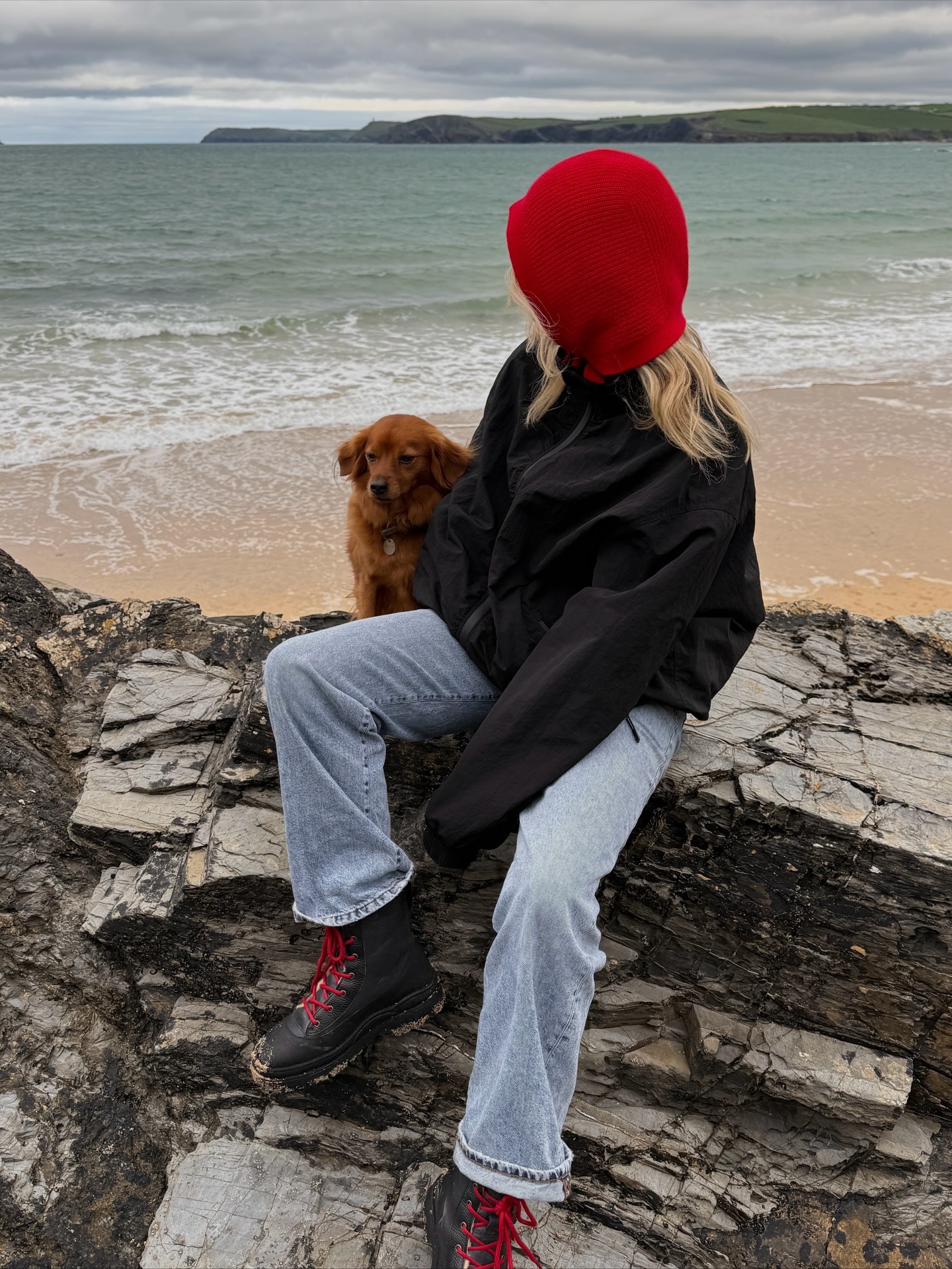 Fashion person Lucy Williams (lucywilliams02) wears a shoe to wear with baggy jeans. She wears black and red walking boots and blue denim jeans.