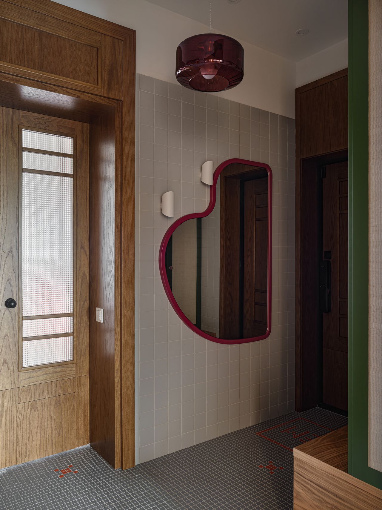 A passageway in an apartment with tiled flooring and walls