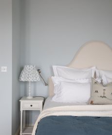 corner of bedroom with pale blue walls