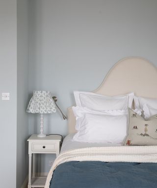 corner of bedroom with pale blue walls