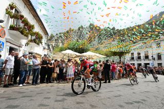 YUNQUERA SPAIN AUGUST 22 Primoz Roglic of Slovenia and Team Red Bull Bora hansgrohe Red Leader Jersey competes passing Grazalema village while fans cheer during the La Vuelta 79th Tour of Spain 2024 Stage 6 a 1855km stage from Jerez de la Frontera to Yunquera UCIWT on August 22 2024 in Yunquera Spain Photo by Dario BelingheriGetty Images