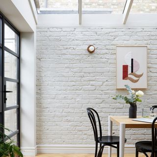 Extension with glass rooflights, patio doors to the garden and a painted brick wall to maintain privacy