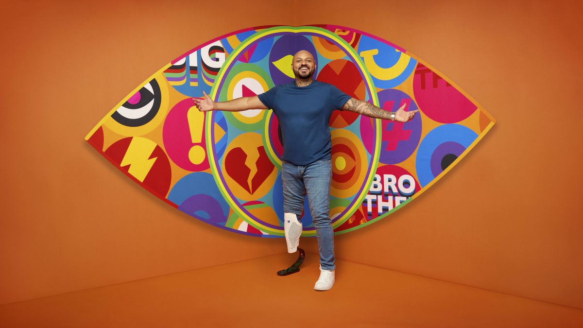 Dylan in front of the Big Brother logo.