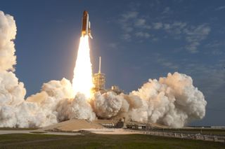 In curling billows of smoke and steam, space shuttle Discovery lifts off from Launch Pad 39A at NASA's Kennedy Space Center in Florida beginning its final flight, the STS-133 mission, to the International Space Station.