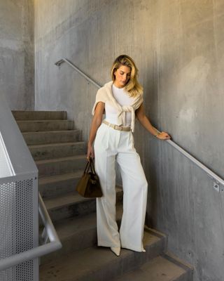 Woman wearing a white T-shirt and white pants.