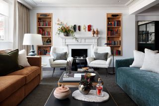 a living room with two sofas and two armchairs