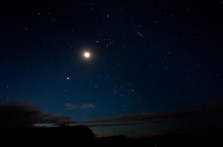The moon and Venus shine bright alongside a Perseid meteor (upper right) on Aug. 12 in this view by photographer Tyler Leavitt in Las Vegas, Nevada, during the peak of the 2012 Perseid meteor shower on Aug. 12.