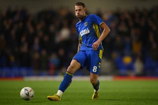 Harry Pell of AFC Wimbledon in action during the Emirates FA Cup second round match between AFC Wimbledon and Chesterfield at The Cherry Red Records Stadium on November 26, 2022 in Wimbledon, England. (Photo by Alex Broadway/Getty Images)