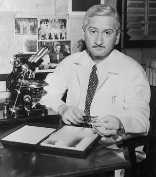 Dr. Albert Sabin sitting in his lab at the University of Cincinnati, where he developed the oral polio vaccine.