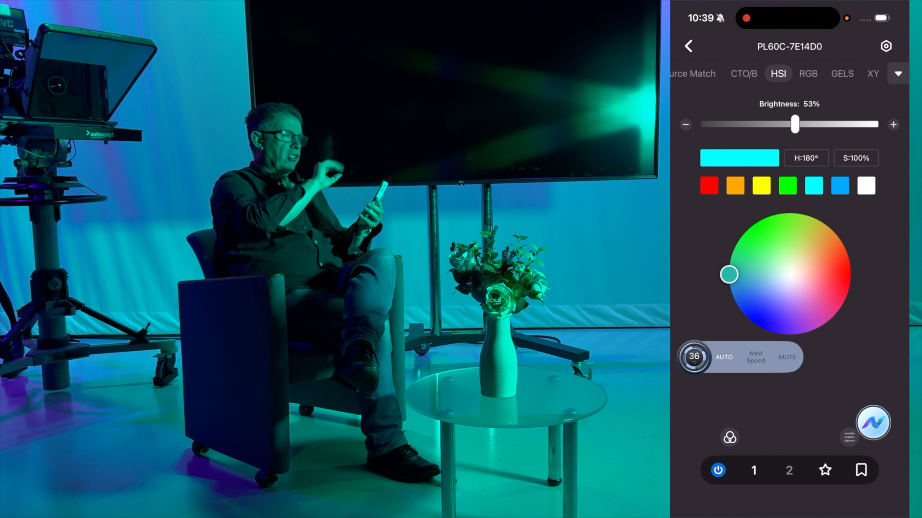 Shot of the reviewer sitting in the front of the camera while controlling the LED&amp;rsquo;s properties remotely via the Neewer app