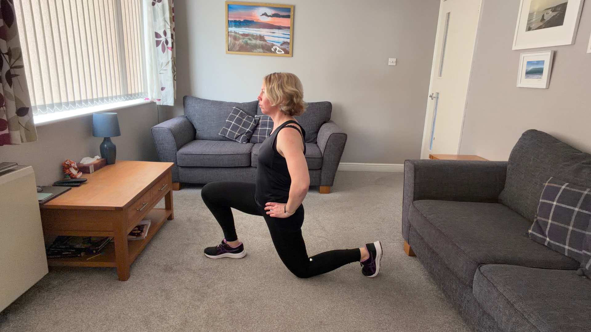 Personal trainer Becky Fuller performing stretching demonstrations in a living room