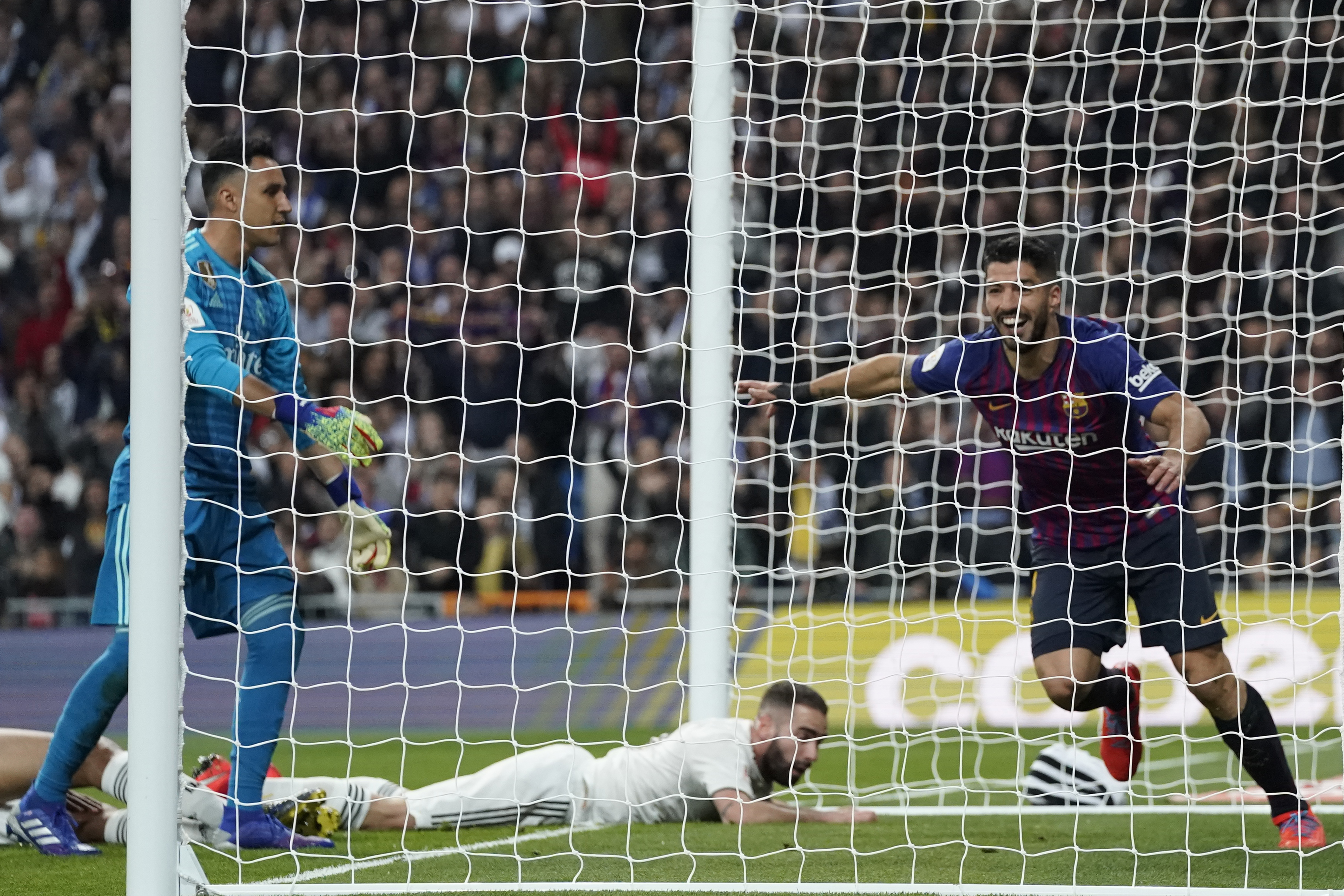 Luis Suarez, right, shows his joy at Raphael Varane's own goal