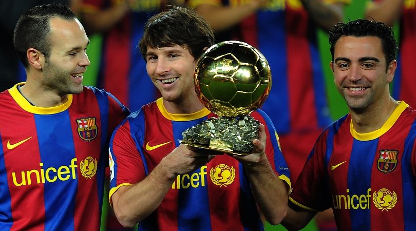 Lionel Messi poses with the Ballon d&#039;Or alongside Barcelona team-mates Xavi and Andres Iniesta at Camp Nou.